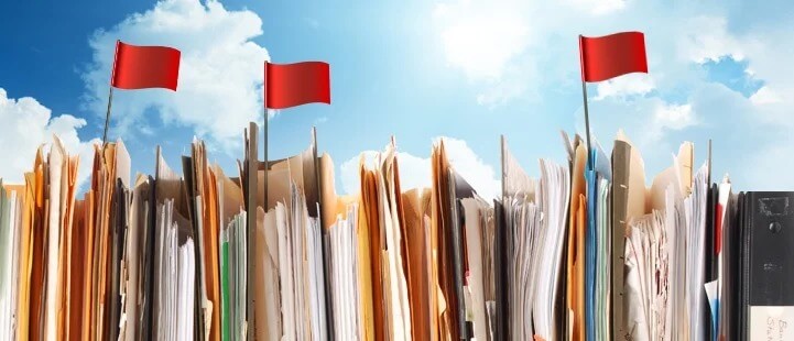stacked folders with red flags 