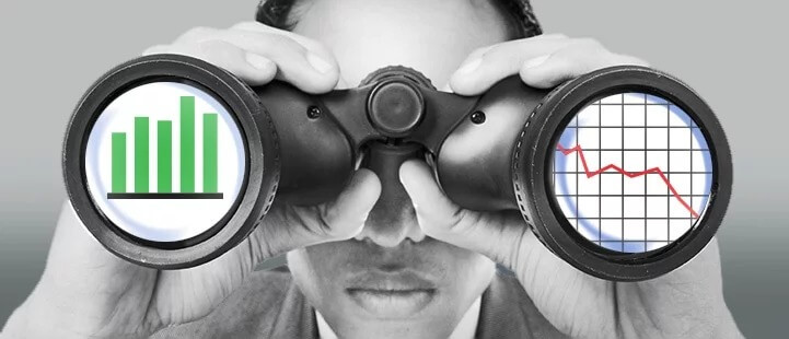 man using binoculars with charts placed on eyeholes